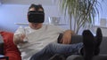 Men in white shirt enjoying vr on sofa virtual reality googles