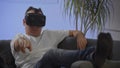 Men in white shirt enjoying vr on sofa virtual reality googles