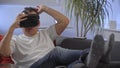 Men in white shirt enjoying vr on sofa virtual reality googles