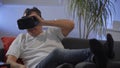 Men in white shirt enjoying vr on sofa virtual reality googles