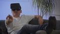Men in white shirt enjoying vr on sofa virtual reality googles