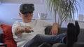 Men in white shirt enjoying vr on sofa virtual reality googles