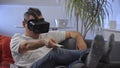 Men in white shirt enjoying vr on sofa virtual reality googles