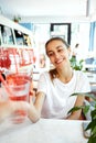 Men and Woman hand giving glass of soft drink in cafe. Red berry lemonade with ice.