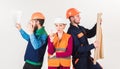 Men and woman in helmets carefree with hammer and project,