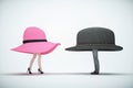 A men and a woman standing face to face with oversized hats Royalty Free Stock Photo