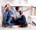 Man and woman assembling furniture at home