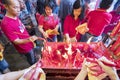 Men and Women burning incensed stick in temple