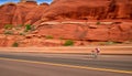 Men and women cycling through eroded sandstone terrain with speed generated by AI