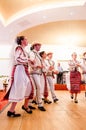 Men and women dancers performing Romanian folk dances