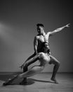 A man and a woman are dancing modern ballet. Acrobatic couple perform number on a white background. A duet of gymnasts