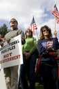 Men and women display signs at tea party rally. Royalty Free Stock Photo