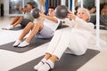 Men and women doing pilates exercises with fitness ball at gym Royalty Free Stock Photo