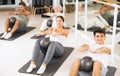 Men and women doing pilates exercises with fitness ball at gym Royalty Free Stock Photo