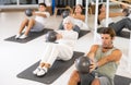 Men and women doing pilates exercises with fitness ball at gym Royalty Free Stock Photo