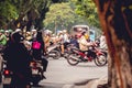 Men and women driving motorbikes and mopeds in a heavy city traffic in Hanoi, Vietnam Royalty Free Stock Photo