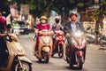 Men and women driving motorbikes and mopeds in a heavy city traffic in Hanoi, Vietnam Royalty Free Stock Photo