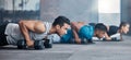 Men, woman and dumbbells in gym workout, training and fitness exercise for health wellness, strong biceps or abs muscles Royalty Free Stock Photo