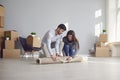 Young couple family with boxes to move in a new house room. Royalty Free Stock Photo