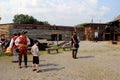 Men and women in period dress, showing visitors how to fire a musket,Fort William Henry,New York,2015