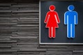 Men and women signs for restroom on modern stone wall background