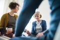 Men and women sitting in a circle during group therapy, supporting each other. Royalty Free Stock Photo