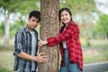 Men and women standing and hugging trees