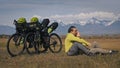 The man and woman travel on mixed terrain cycle touring with bikepacking. The two people journey with bicycle bags