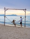 Men and women watching sunset from a hammock on the beach in Pattaya Thailand Ban Amphur beach Royalty Free Stock Photo