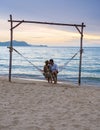 Men and women watching sunset from a hammock on the beach in Pattaya Thailand Ban Amphur beach Royalty Free Stock Photo