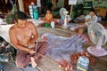 Men and women weave a fishing net in the village Royalty Free Stock Photo