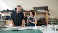 A man and a woman work as tanners in a workshop. Royalty Free Stock Photo