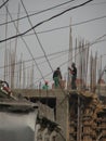 Men work on a building in Baku, Azerbaijan with huge iron rods protruding