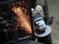 Men at work grinding steel
