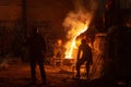 Men work with hot metal in a steel factory