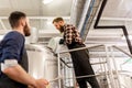 Men working at craft brewery or beer plant Royalty Free Stock Photo