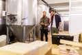 Men working at craft brewery or beer plant Royalty Free Stock Photo