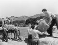 Men working on a farm loading hay Royalty Free Stock Photo