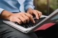 Men working on laptop keyboard at outdoor.