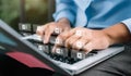 Men working on laptop keyboard at outdoor