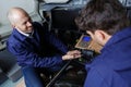 men working on remote control in cockpit factory