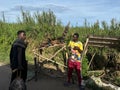 Men working at a stall on the side of the road selling fish have a discussion