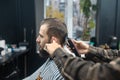 Master in barbershop makes men& x27;s haircutting with hair clipper Royalty Free Stock Photo