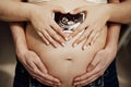 men& x27;s hands hold pregnant woman& x27;s abdomen, and female hold photo ultrasound Royalty Free Stock Photo