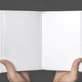 Men& x27;s hands hold a white book with clean pages Royalty Free Stock Photo