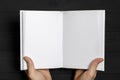 Men& x27;s hands hold a white book with clean pages Royalty Free Stock Photo