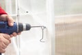 men's hands screw screws to the bar on the greenhouse with a screwdriver Royalty Free Stock Photo