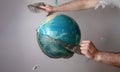 Men& x27;s hands tear off a plastic bag from the globe of planet Earth. The concept of environmental protection. Eco. Copy Royalty Free Stock Photo