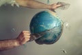 Man& x27;s hands tear off a plastic bag from the globe of planet Earth. Concept of environmental protection. Eco Royalty Free Stock Photo