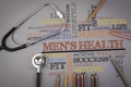 Men's health. Colored pencils and a stetoscope on the table